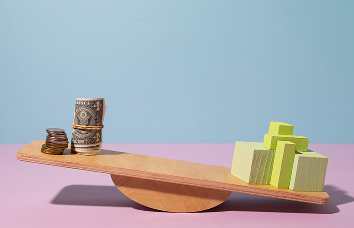 Balance scale with money and blocks